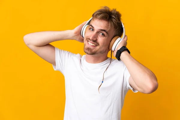 Jonge Knappe Blonde Man Geïsoleerd Gele Achtergrond Luisteren Muziek — Stockfoto