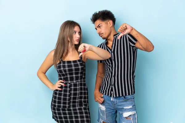 Teenager Caucasian Couple Isolated Blue Background Showing Thumb Sign Negative — Stock Photo, Image