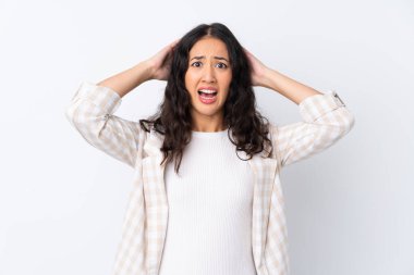 Karma ırk kadını, soyutlanmış beyaz arka planda hayal kırıklığına uğramış ve ellerini başının üstüne koyuyor.