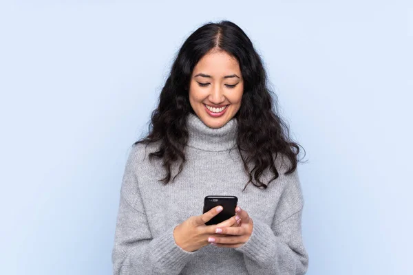 Spagnolo Donna Cinese Sfondo Blu Isolato Invio Messaggio Con Cellulare — Foto Stock