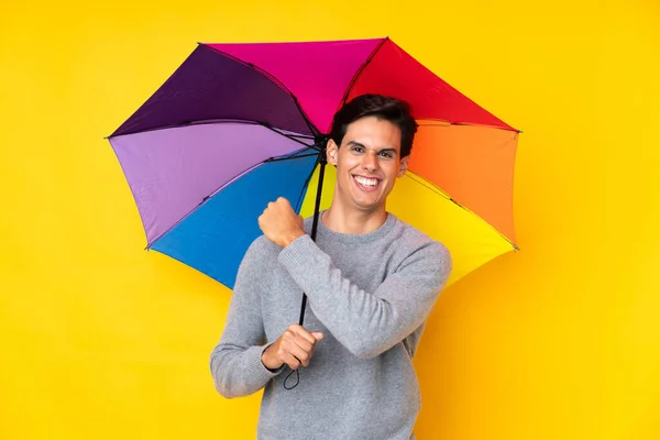 Hombre Sosteniendo Paraguas Sobre Aislado Fondo Amarillo Celebrando Una Victoria — Foto de Stock