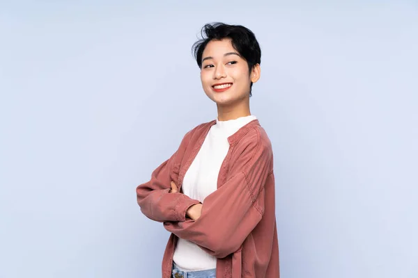 Junge Asiatische Mädchen Über Isolierten Blauen Hintergrund Mit Verschränkten Armen — Stockfoto