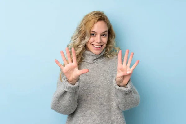 Jonge Blonde Vrouw Het Dragen Van Een Trui Geïsoleerd Blauwe — Stockfoto