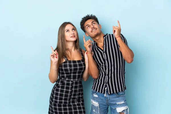Teenager Caucasian Couple Isolated Blue Background Pointing Index Finger Great — Stock Photo, Image
