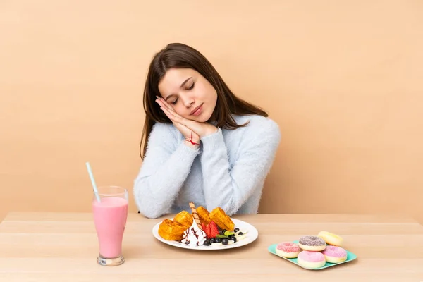 Chica Adolescente Comiendo Gofres Aislados Sobre Fondo Beige Haciendo Gesto —  Fotos de Stock