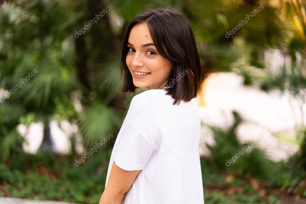 Young happy caucasian woman at outdoors