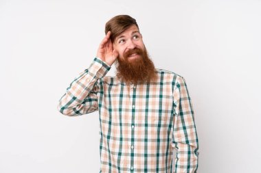 Uzun sakallı, soyutlanmış beyaz bir geçmişi olan, kuşkulu ve kafası karışık bir yüzü olan kızıl saçlı bir adam.