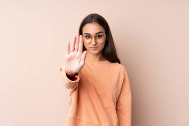 İzole edilmiş bir geçmişi olan genç bir kız elleriyle jesti durduruyor.