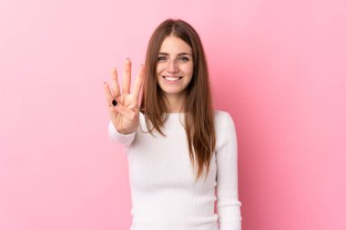 Soyutlanmış pembe arka planı olan genç bir kadın mutlu ve parmakları olan dört kişi sayıyor.