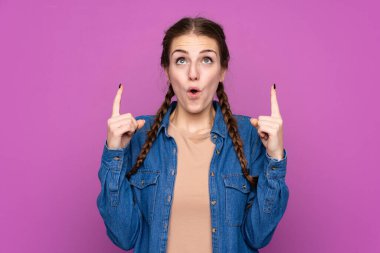 İzole edilmiş mor arka planı olan genç bir kadın işaret parmağıyla işaret etmek harika bir fikir.