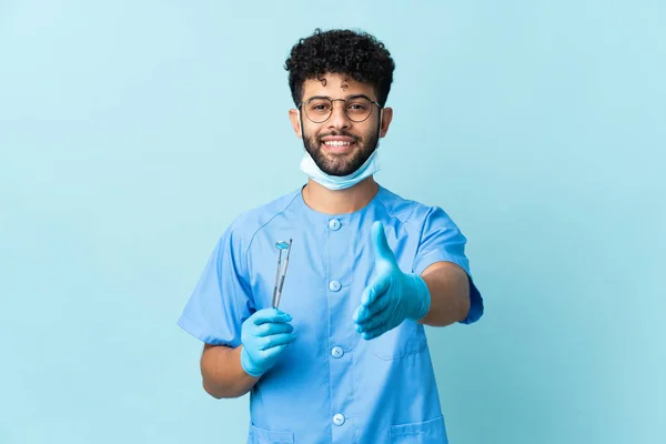 Moroccan Dentist Man Holding Tools Isolated Blue Background Shaking Hands — Stock Photo, Image