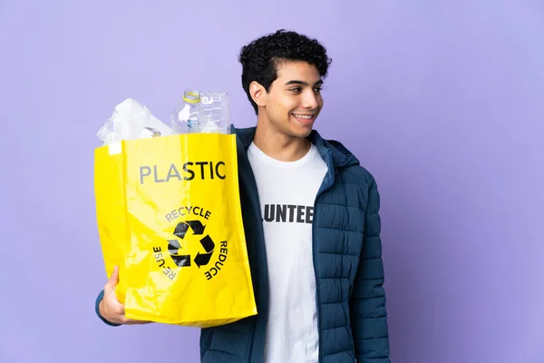 Young Venezuelan Man Holding Bag Full Plastic Bottles Looking Side — Stock Photo, Image