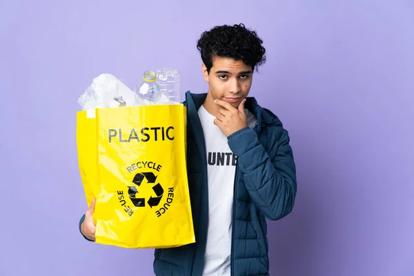 Young Venezuelan Man Holding Bag Full Plastic Bottles Thinking — Stock Photo, Image