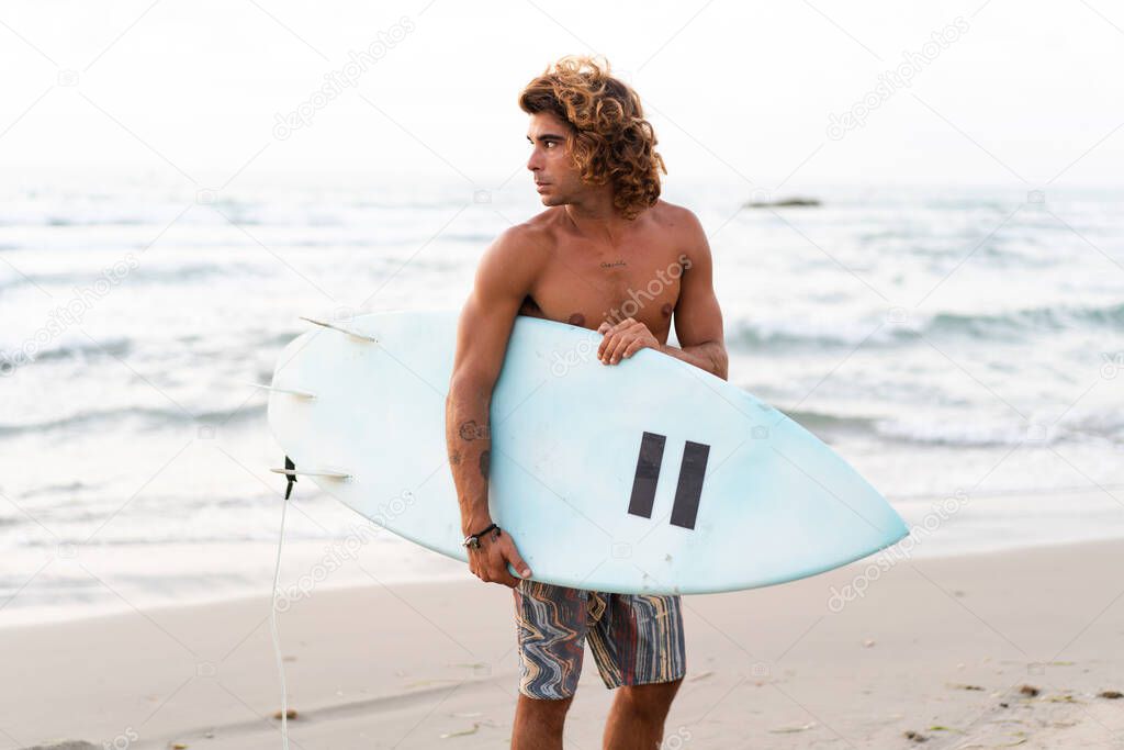 Young caucasian man get up early to  doing surf at sunrise