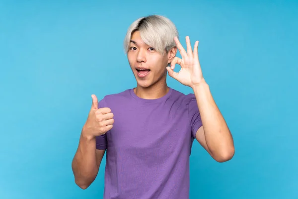 Young Asian Man Isolated Blue Background Showing Sign Thumb Gesture — Stock Photo, Image