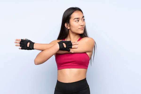 Jonge Indiase Sport Vrouw Geïsoleerd Blauwe Achtergrond Stretching Arm — Stockfoto