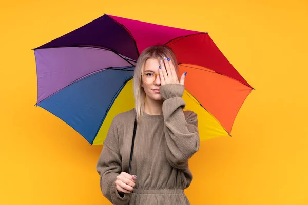 Young Blonde Woman Holding Umbrella Isolated Yellow Wall Covering Eye — Stock Photo, Image