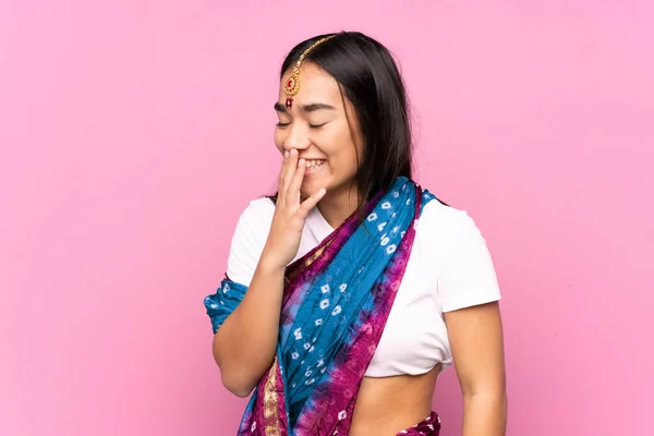 Young Indian woman with sari over isolated background smiling a lot