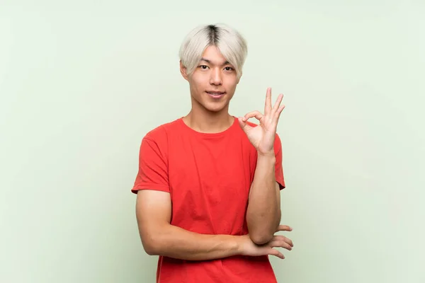 Mladý Asijský Muž Přes Izolované Zelené Pozadí Ukazující Znamení Prsty — Stock fotografie