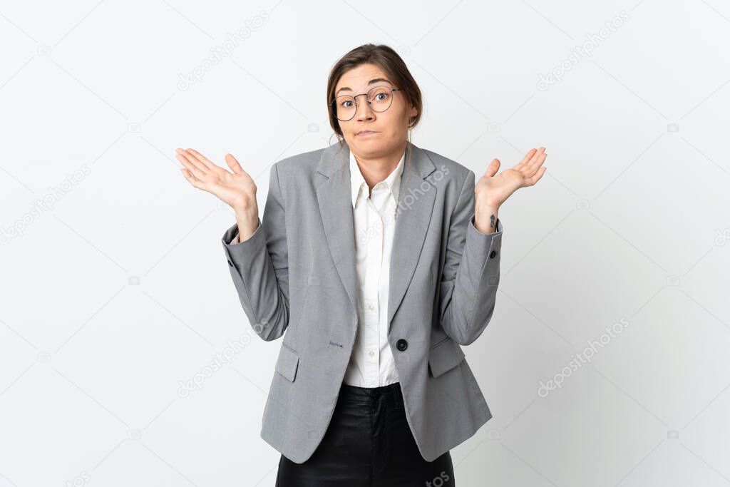 Business Ireland woman isolated on white background having doubts while raising hands