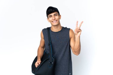 Spor yapan, gülümseyen ve zafer işareti gösteren Arjantinli genç adam.