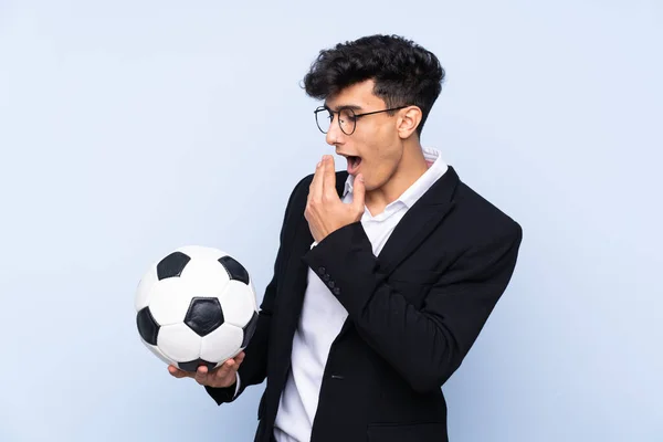 Argentinian Soccer coach over isolated blue background with surprise and shocked facial expression