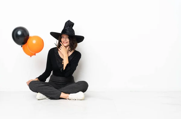 Young Witch Holding Black Orange Air Balloons Sitting Floor Happy — Stock Photo, Image