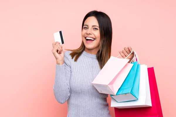 Frau Vor Isoliertem Rosa Hintergrund Hält Einkaufstüten Und Kreditkarte Der — Stockfoto