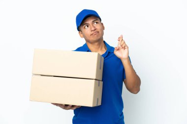 Delivery Ecuadorian man isolated on white background with fingers crossing and wishing the best