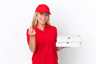 Delivery woman holding pizzas isolated on white background making money gesture