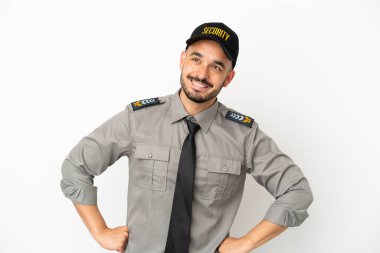 Young security  caucasian man isolated on white background posing with arms at hip and smiling