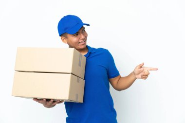 Delivery Ecuadorian man isolated on white background pointing finger to the side and presenting a product