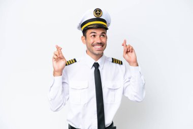 İzole edilmiş beyaz arka plan üzerinde parmakları çapraz olan uçak pilotu