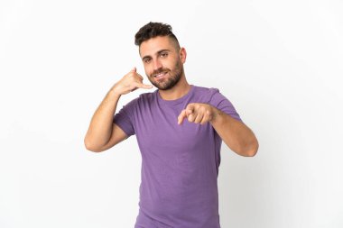 Caucasian man isolated on white background making phone gesture and pointing front