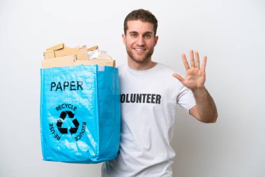 Young caucasian man holding a recycling bag full of paper to recycle isolated on white background counting five with fingers