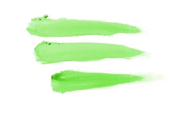 Smear and texture of lipstick or acrylic paint isolated on white background. Green color