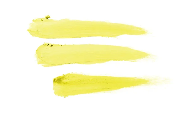 Rozmaz i tekstury szminki lub farby akrylowej na białym tle. Kolor żółty — Zdjęcie stockowe