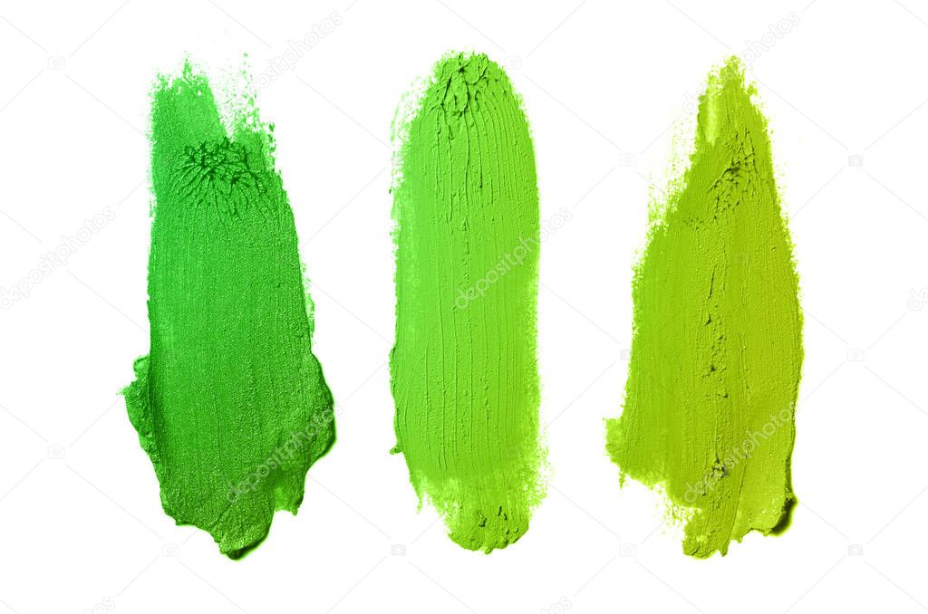 Smear and texture of lipstick or acrylic paint isolated on white background. Green yellow color