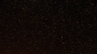 Titreyen altın parçacıkları ve ışık parlamasının soyut sahte parıltı ışıkları