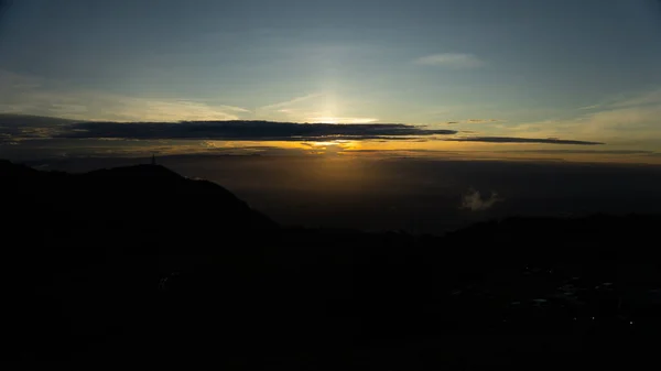 View of landscape with light sunrise on the horizon in the valley. Bright sky over mist mountains. Concept of nature. Tourist attraction Phu Thap Berk, Phetchabun, Thailand