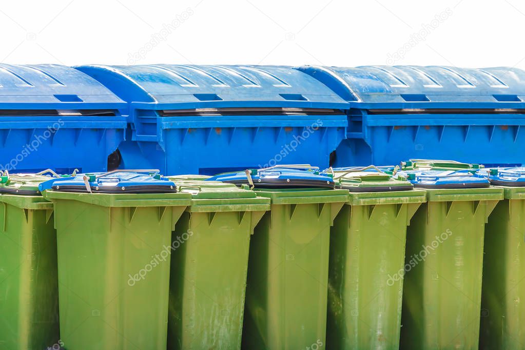 Large blue and small green waste containers isolated on a white background