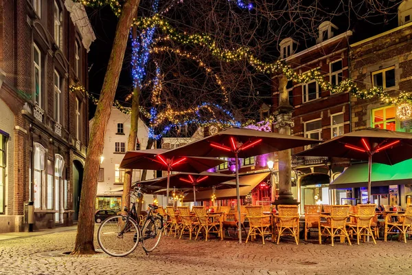 Bars and restaurants with christmas lights on the Sint Amorsplein square in Maastricht, The Netherlands