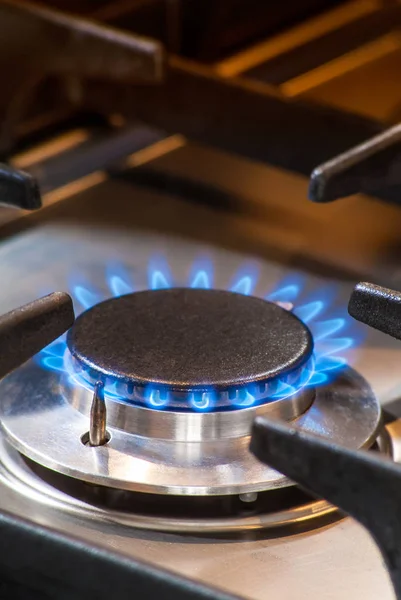 Deatil of a burning gas stove with blue flames