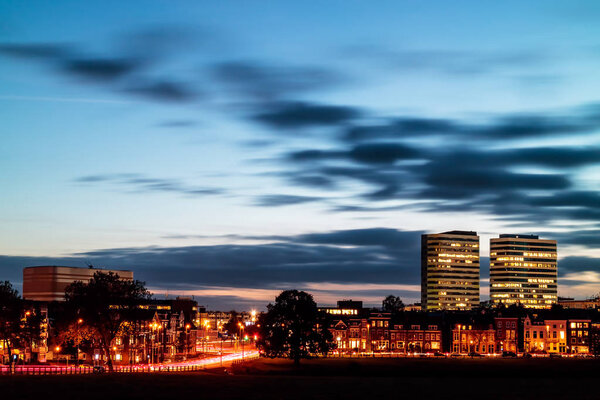 Evening view of the central railway station area with offices and luxury houses in the Dutch city of Arnhem, The Netherlands