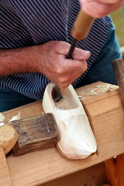 Farmer demonstrating the making of Dutch wooden clogs