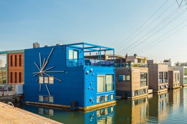 Row of contemporary house boats in the IJburg district in Amster clipart