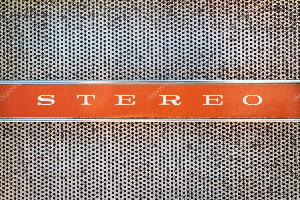 Close up of a vintage jukebox with the text stereo on an orange background