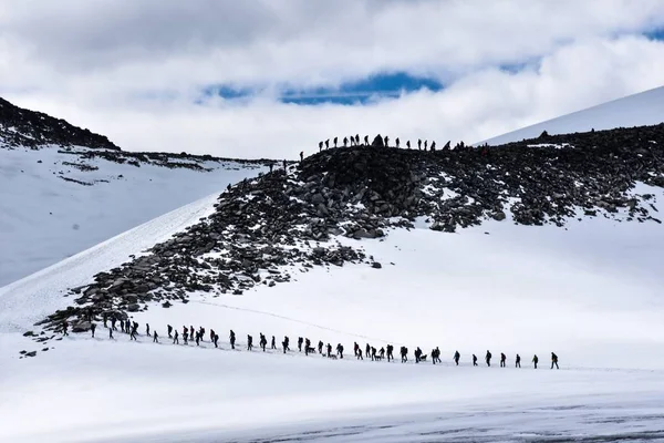 A large group climbing a mountain