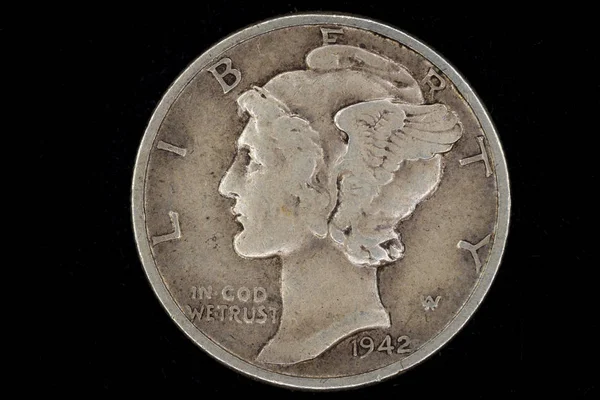 Old Liberty Mercury head silver dime coin on black background