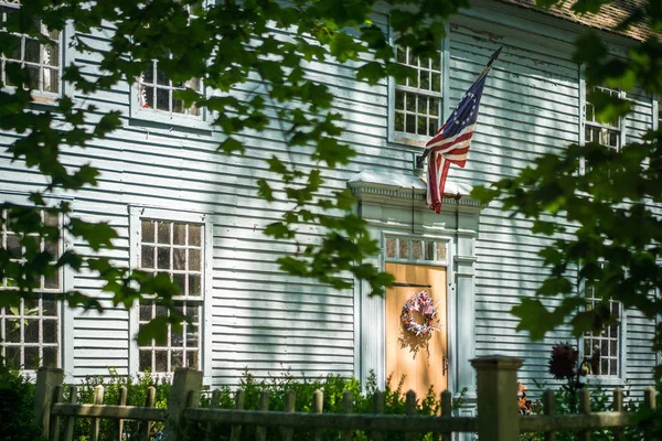 Historic wood frame house with flag
